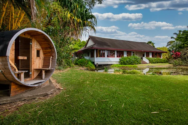 a front view of house with a garden