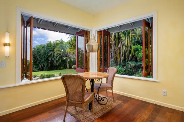a view of a room with furniture and wooden floor