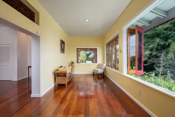 a view of outdoor space with wooden floor and windows