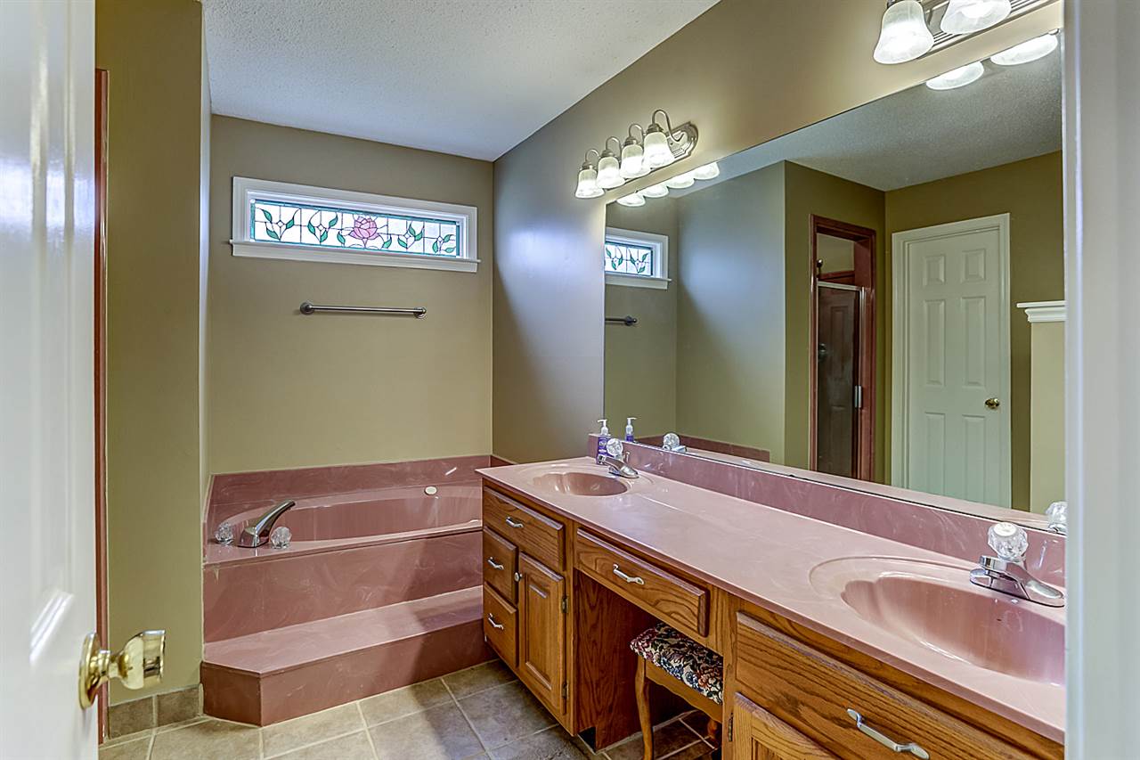 9445 Pleasant Ridge Road Lakeland, TN 38002 - Photo 13 of 21 The Master Bathroom has a large walk in closet, ceramic tile floors, garden tub, double vanities with sit down bench, separate shower.