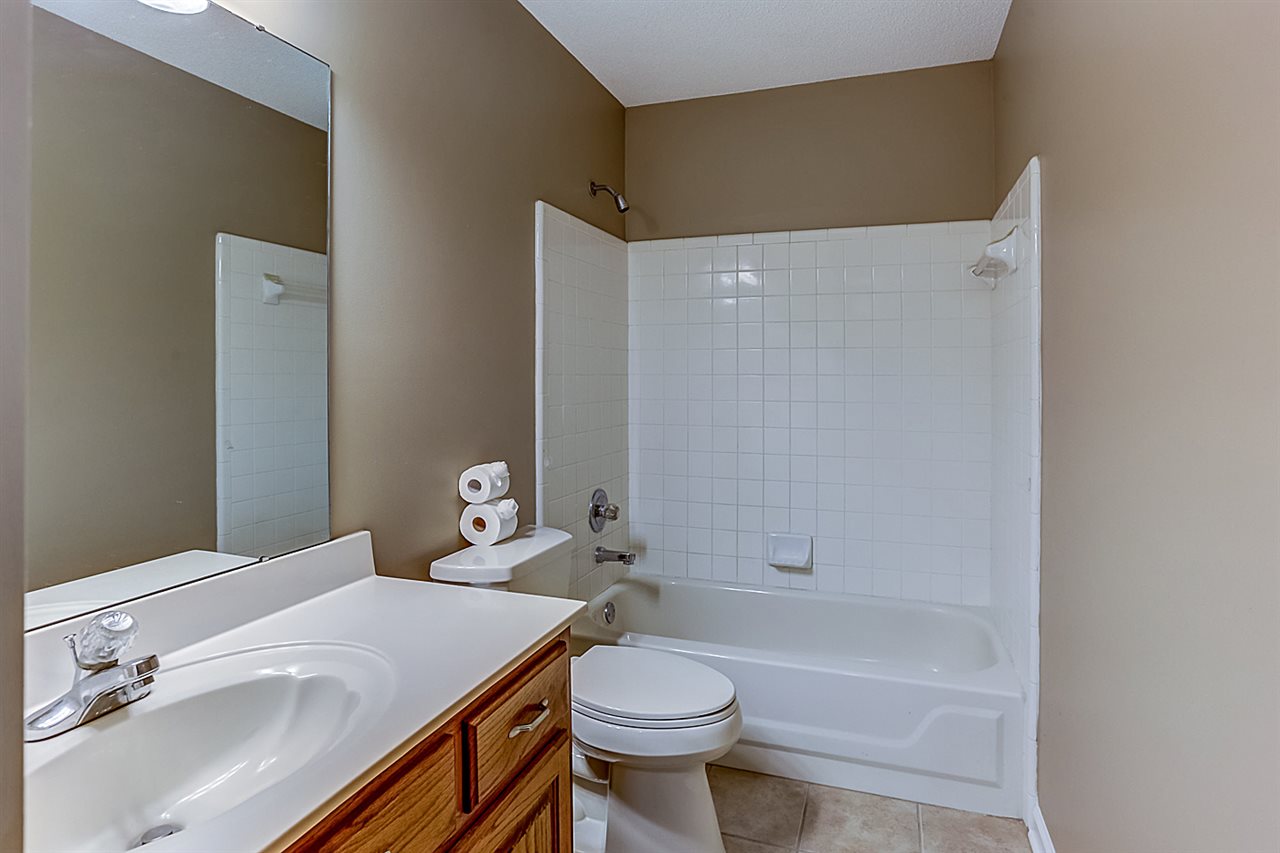 9445 Pleasant Ridge Road Lakeland, TN 38002 - Photo 15 of 21 Downstairs full bathroom shared by the additional two bedrooms has full bath/shower and single vanity sink.