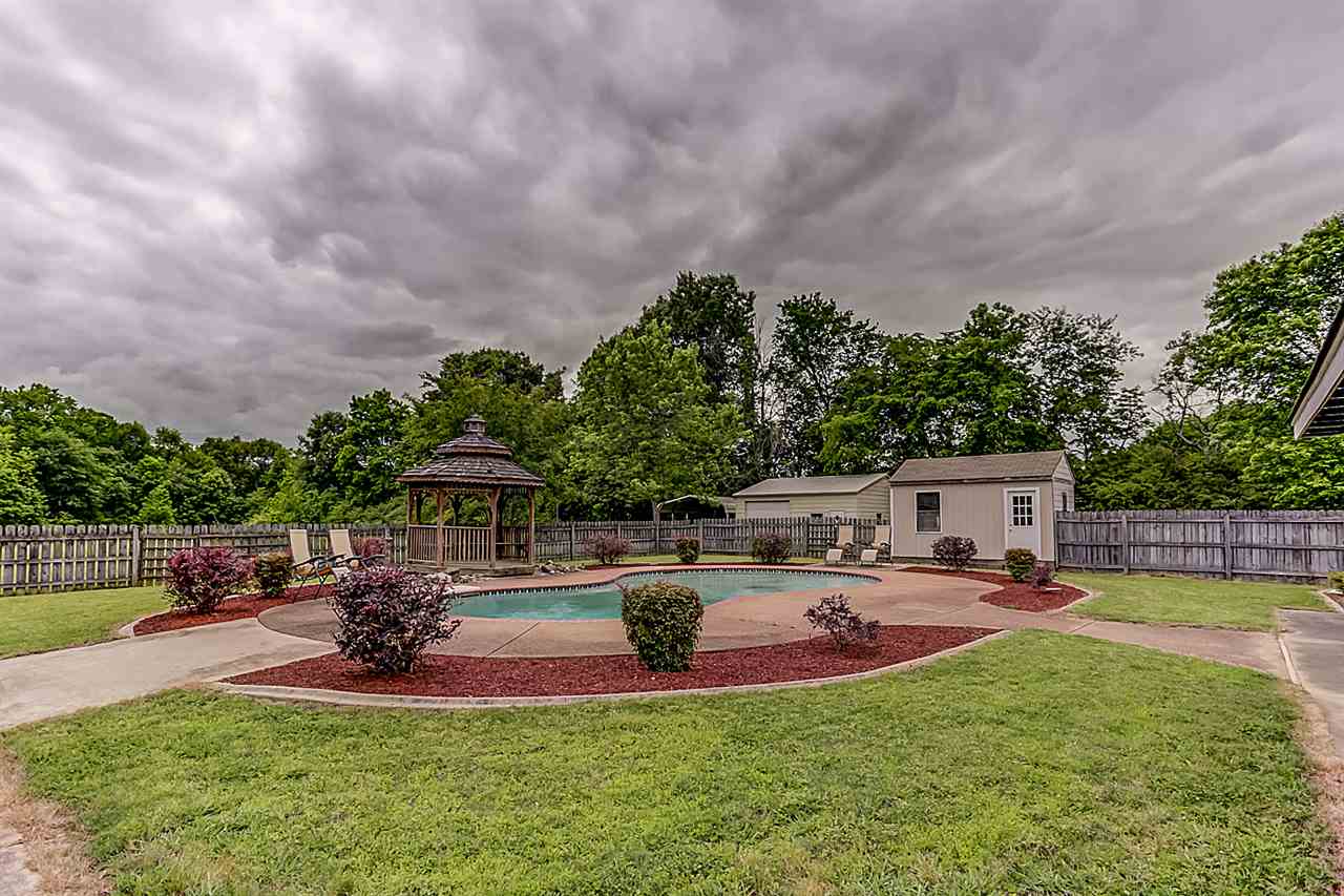 9445 Pleasant Ridge Road Lakeland, TN 38002 - Photo 19 of 21 Step outside to the professionally landscaped backyard complete with gunite pool, diving board, gazebo, 10x16 pool equipment shed, wood fenced backyard.