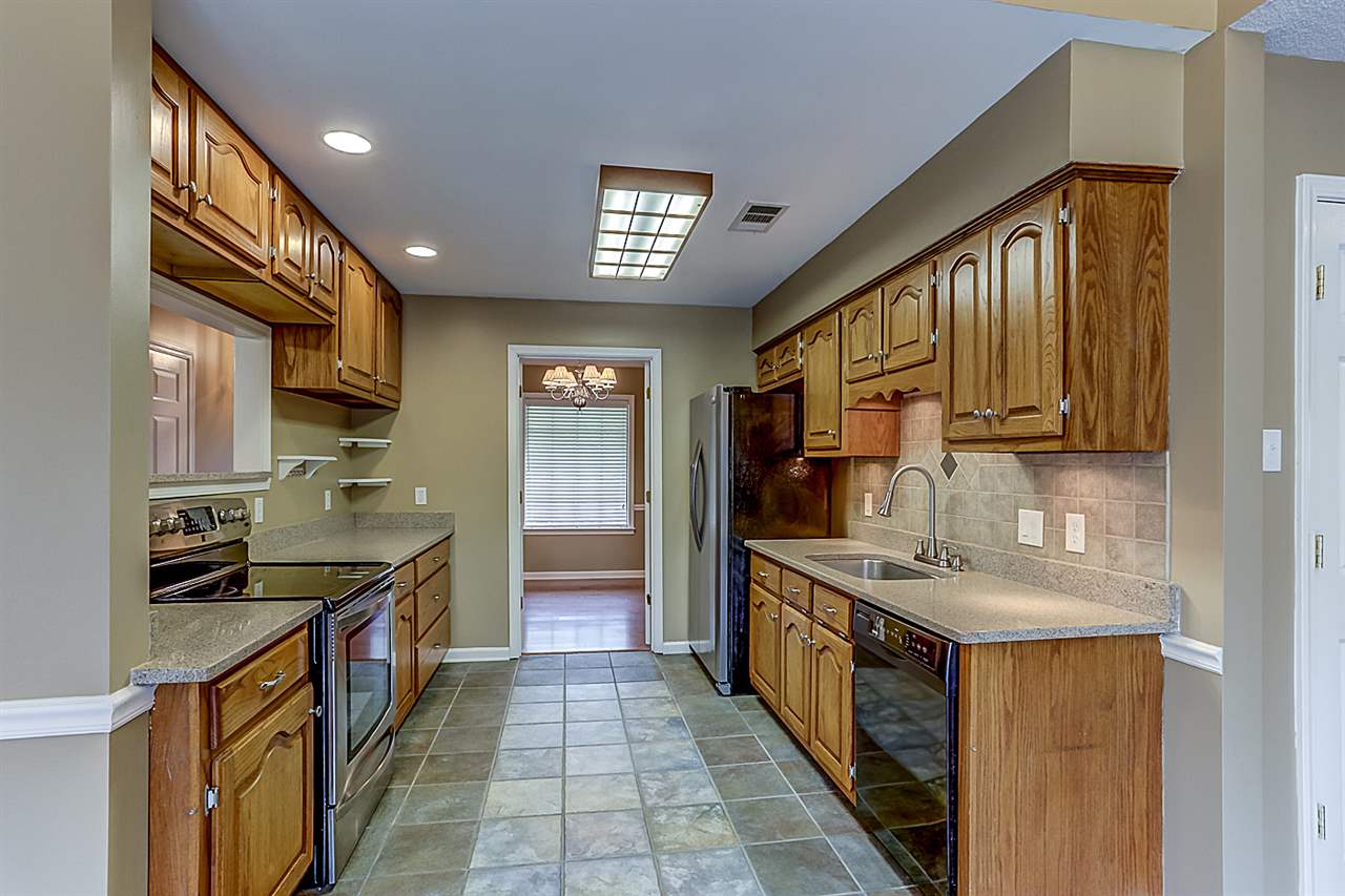9445 Pleasant Ridge Road Lakeland, TN 38002 - Photo 7 of 21 This 20x10 Kitchen has ceramic tile floors, custom tile backsplash, silestone countertops, SS refrigerator, Kenmore stove w/electric smooth cooktop and dishwasher. See through bar area w/custom barstools.