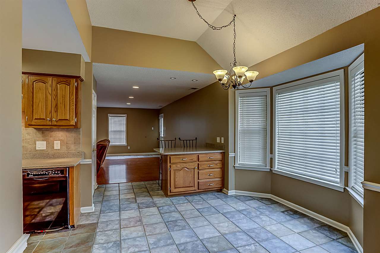 9445 Pleasant Ridge Road Lakeland, TN 38002 - Photo 8 of 21 Breakfast area has a separate sit down counter with additional bar stools. Ceramic tile, chandelier, bay window w/2 inch blinds and separate pantry.