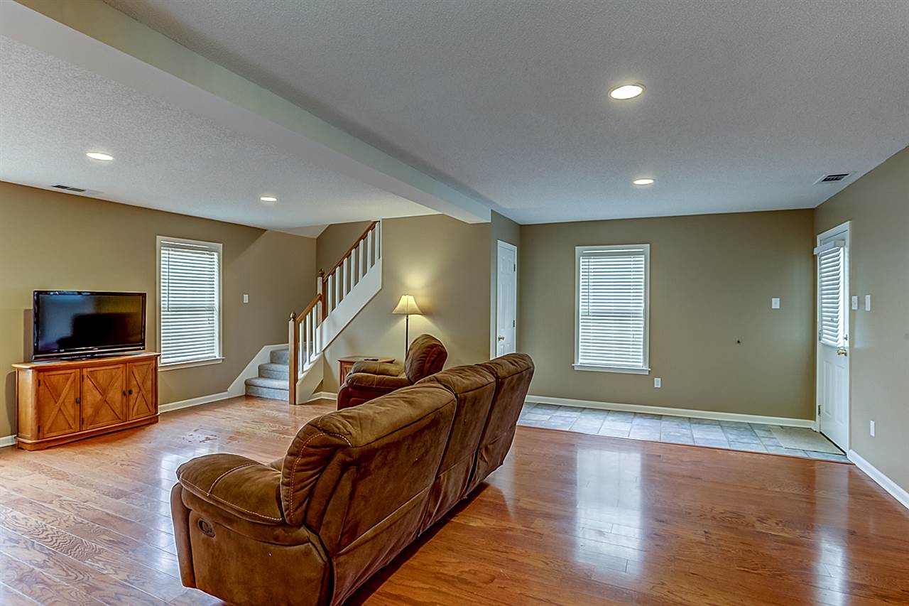 9445 Pleasant Ridge Road Lakeland, TN 38002 - Photo 10 of 21 This additional 23x18 Great Room has hardwood floors, a full separate bathroom and its own entry to the covered patio.