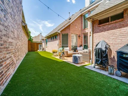 a view of a house with backyard and porch