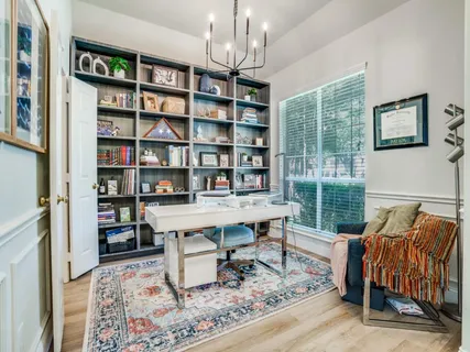 a work room with furniture rug and window