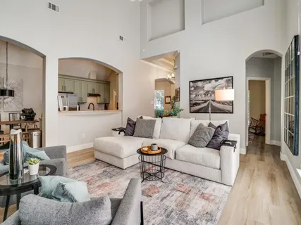 a living room with furniture and wooden floor