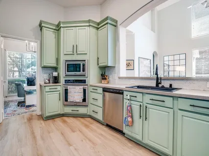 a kitchen with a sink stove and cabinets