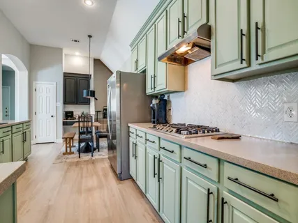 a kitchen with stainless steel appliances granite countertop a stove and a refrigerator