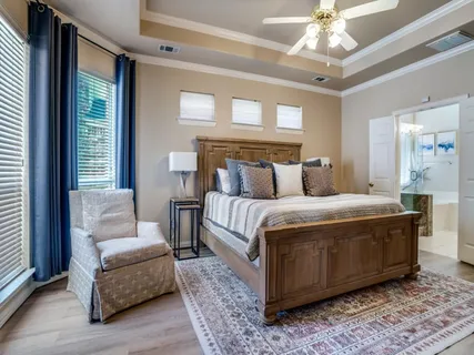 a spacious bedroom with a large bed and a couch