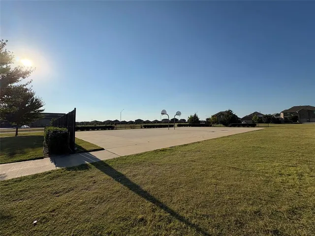 a view of a fountain in front of a house with a big yard