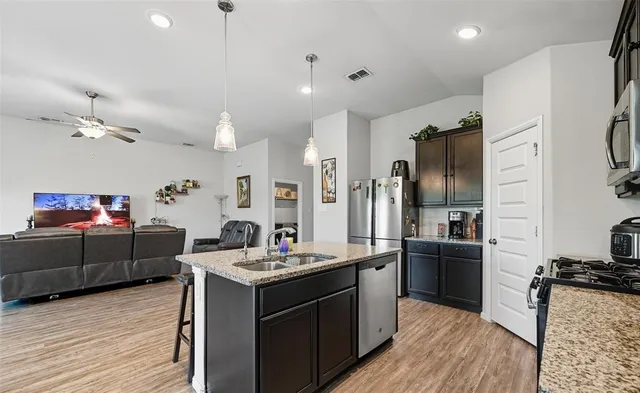 a kitchen with a sink stove and refrigerator