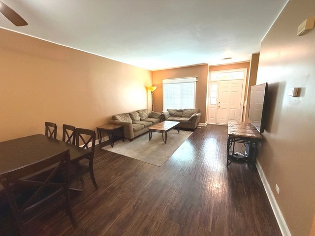 2298 Reflections Drive, Unit 2298 Aurora, IL 60502 - Photo 12 of 26 a living room with furniture wooden floor and a table
