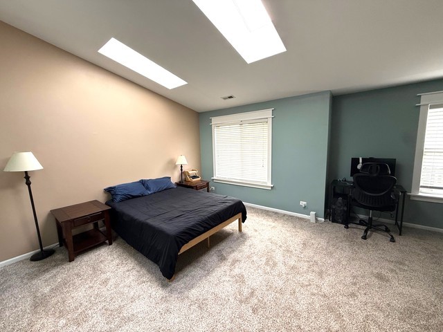 2298 Reflections Drive, Unit 2298 Aurora, IL 60502 - Photo 14 of 26 a living room with furniture a flat screen tv and a window