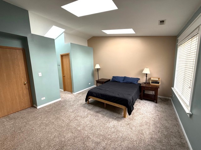 2298 Reflections Drive, Unit 2298 Aurora, IL 60502 - Photo 18 of 26 a bedroom with a bed and a window