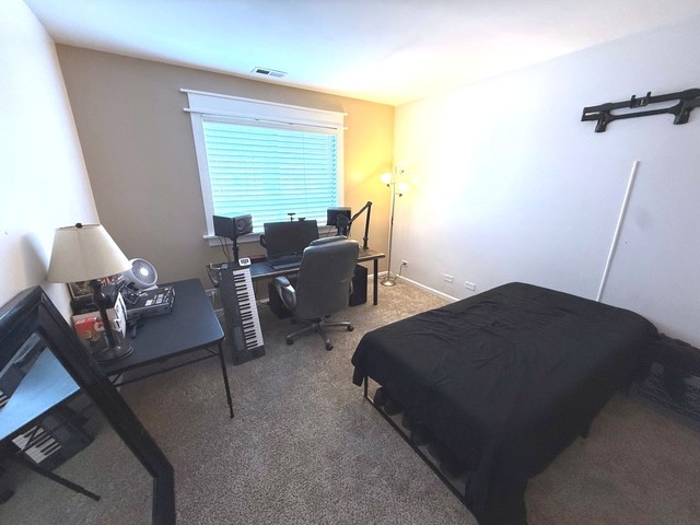2298 Reflections Drive, Unit 2298 Aurora, IL 60502 - Photo 24 of 26 a living room with furniture and a window