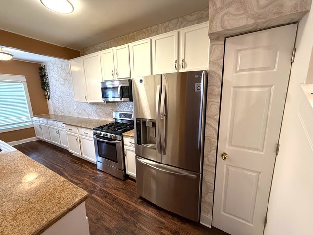 2298 Reflections Drive, Unit 2298 Aurora, IL 60502 - Photo 4 of 26 a kitchen with stainless steel appliances granite countertop a refrigerator and a sink
