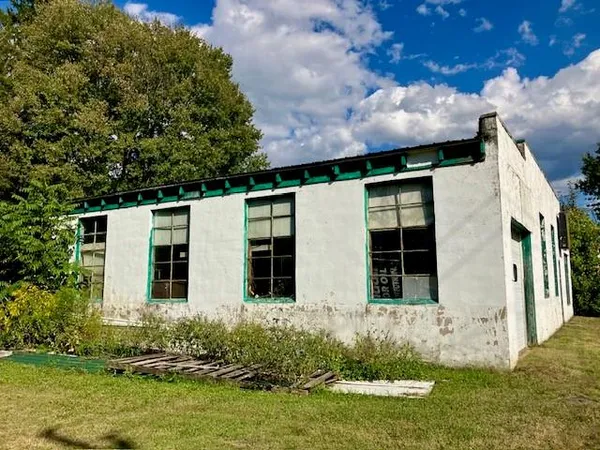 an aerial view of a house a yard and street
