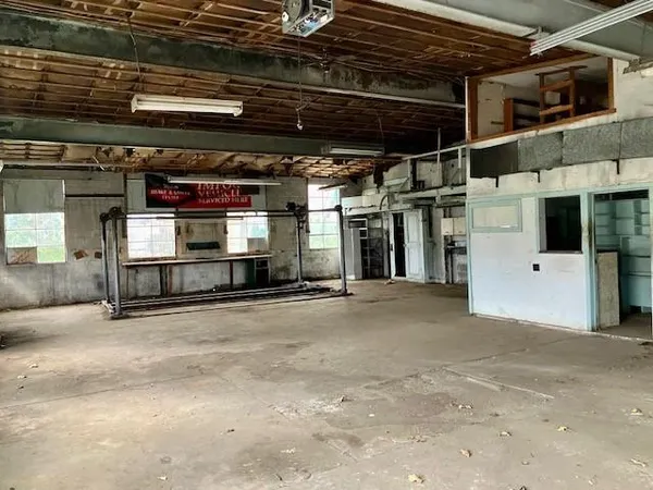 a view of a house with a yard deck and a tree