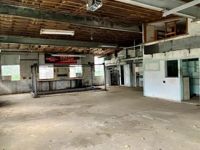 a view of a house with a yard deck and a tree