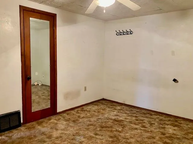 a view of a room with a air conditioner and a window