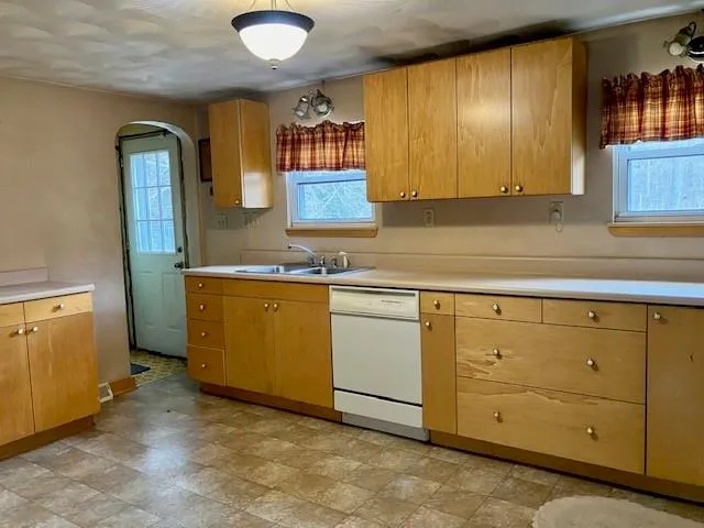 a kitchen with white cabinets sink and white appliances