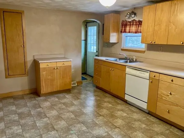 a view of a kitchen with a refrigerator a stove top oven a refrigerator and a stove