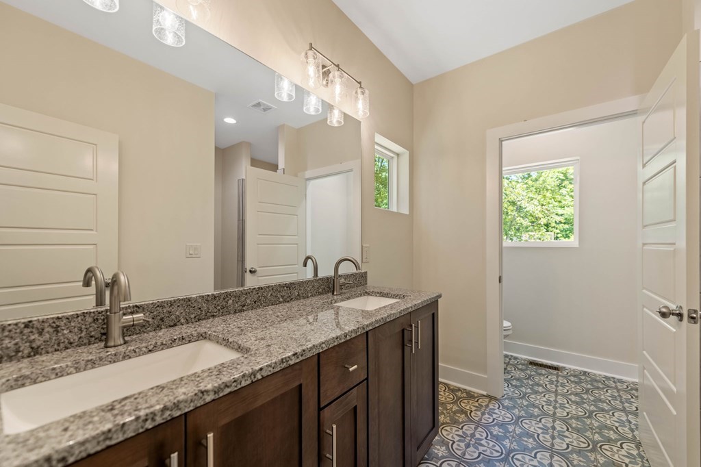 1001 Sunset Road Epworth, GA 30541 - Photo 18 of 36 a bathroom with a granite countertop sink and a mirror