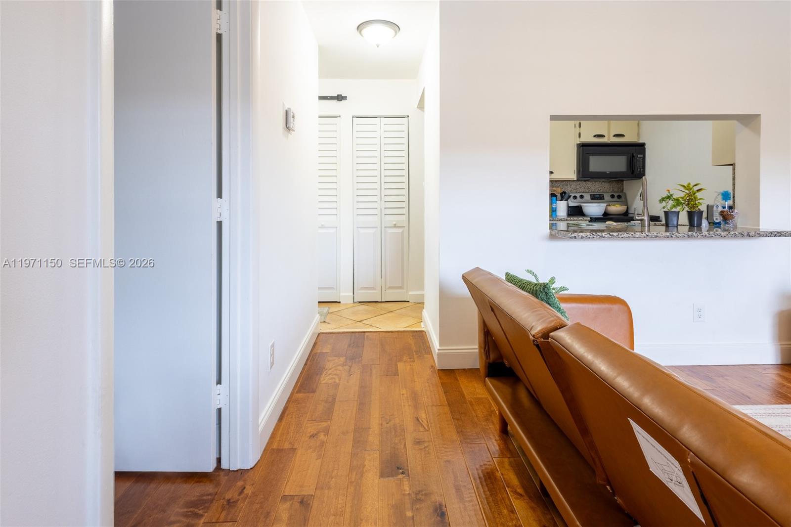 9430 Boca Cove Circle, Unit 210 Boca Raton, FL 33428 - Photo 13 of 24 a dining room with furniture and a wooden floor