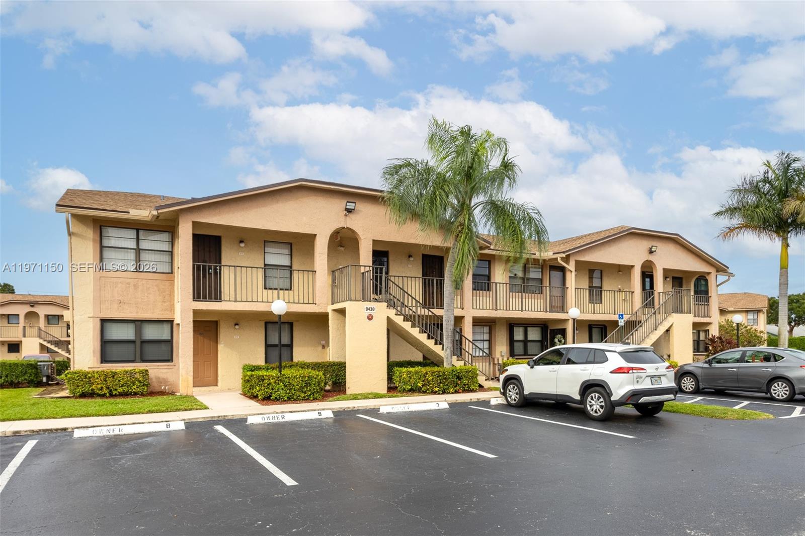 9430 Boca Cove Circle, Unit 210 Boca Raton, FL 33428 - Photo 16 of 24 a car parked in front of a white building