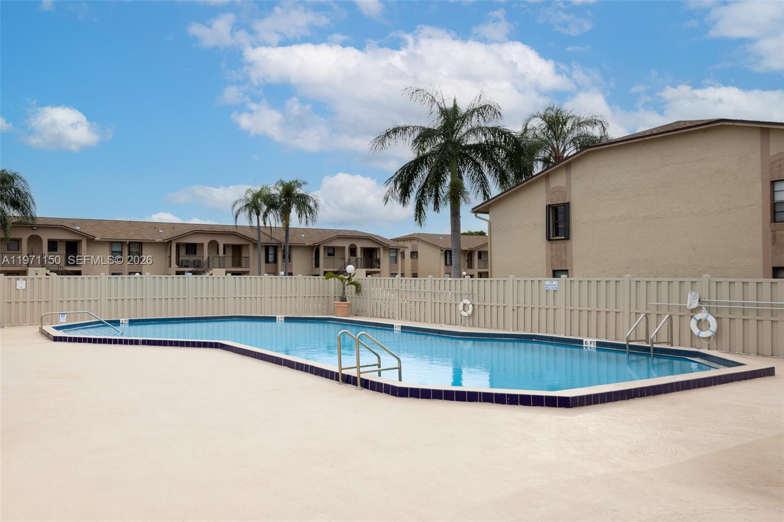 9430 Boca Cove Circle, Unit 210 Boca Raton, FL 33428 - Photo 17 of 24 a front view of a house with a garden