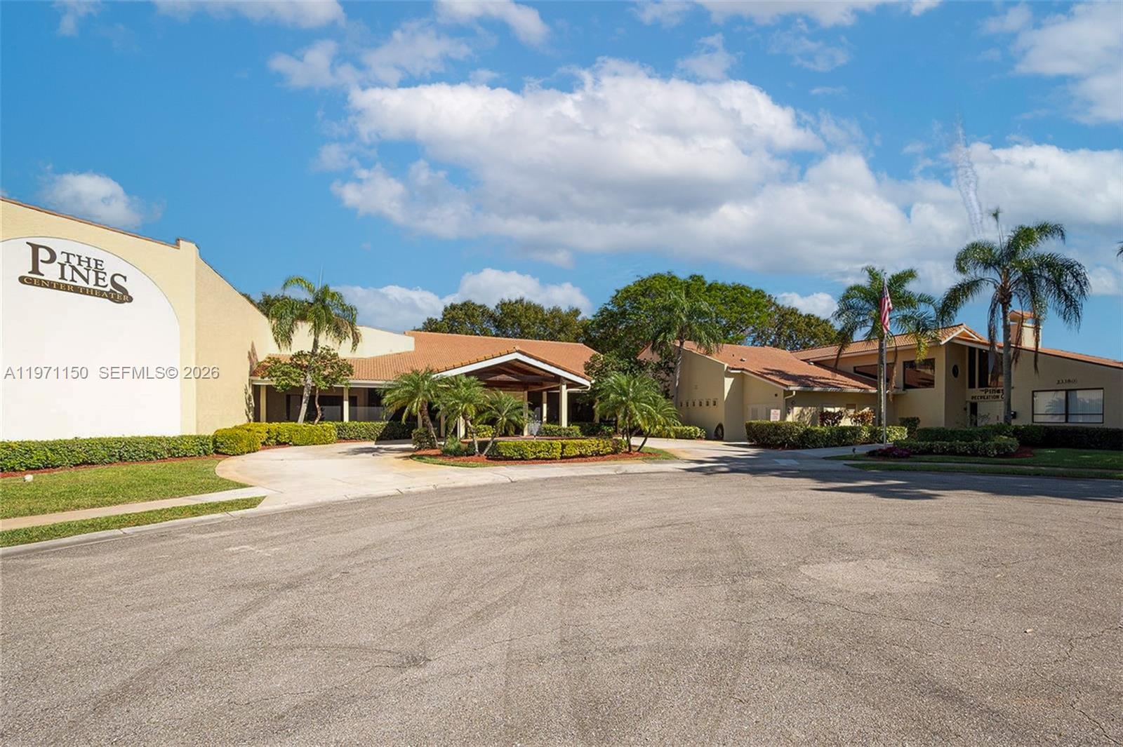 9430 Boca Cove Circle, Unit 210 Boca Raton, FL 33428 - Photo 20 of 24 a view of a house with a yard and fence