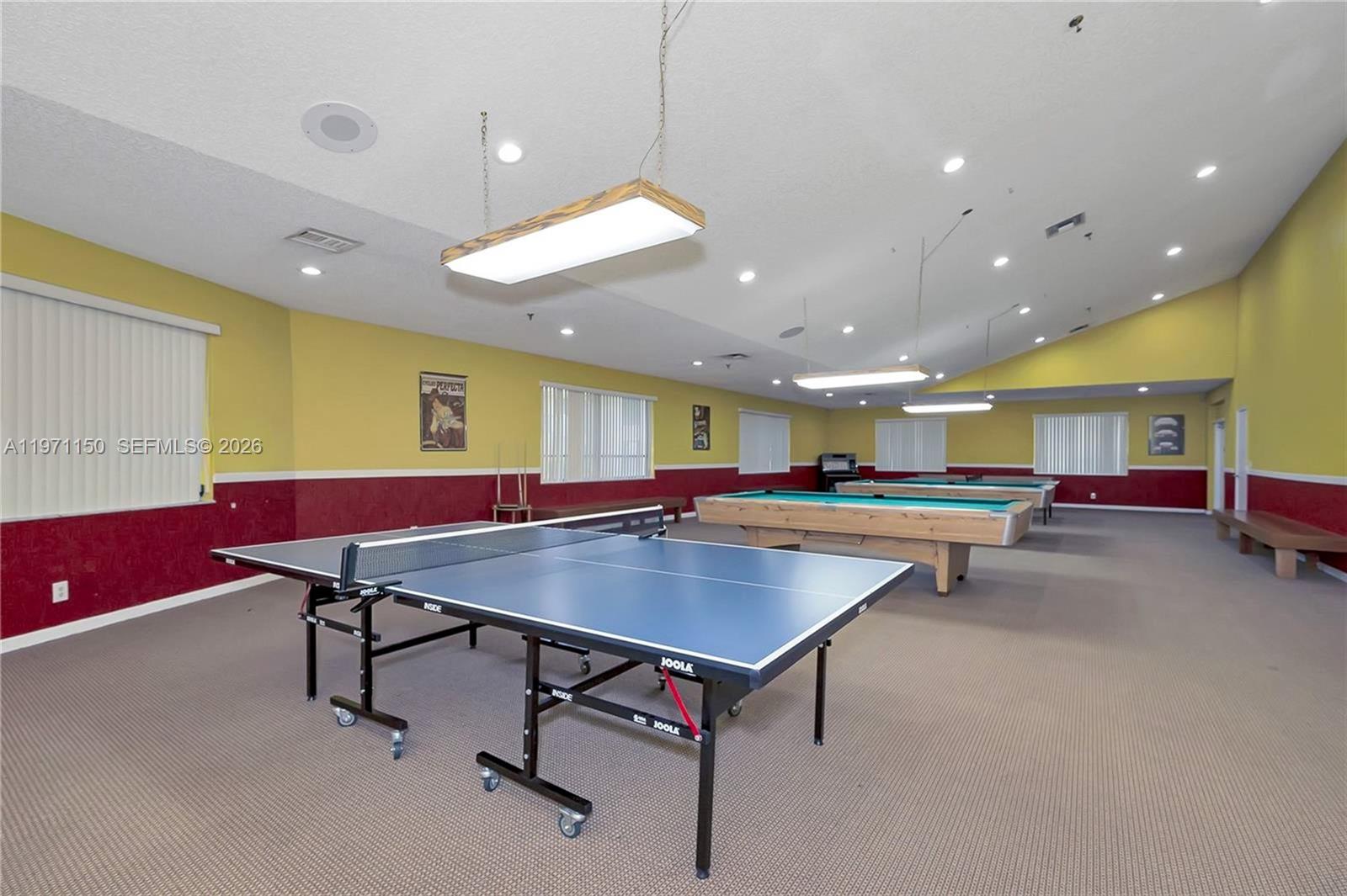 9430 Boca Cove Circle, Unit 210 Boca Raton, FL 33428 - Photo 21 of 24 a room with furniture and a table with wooden floor