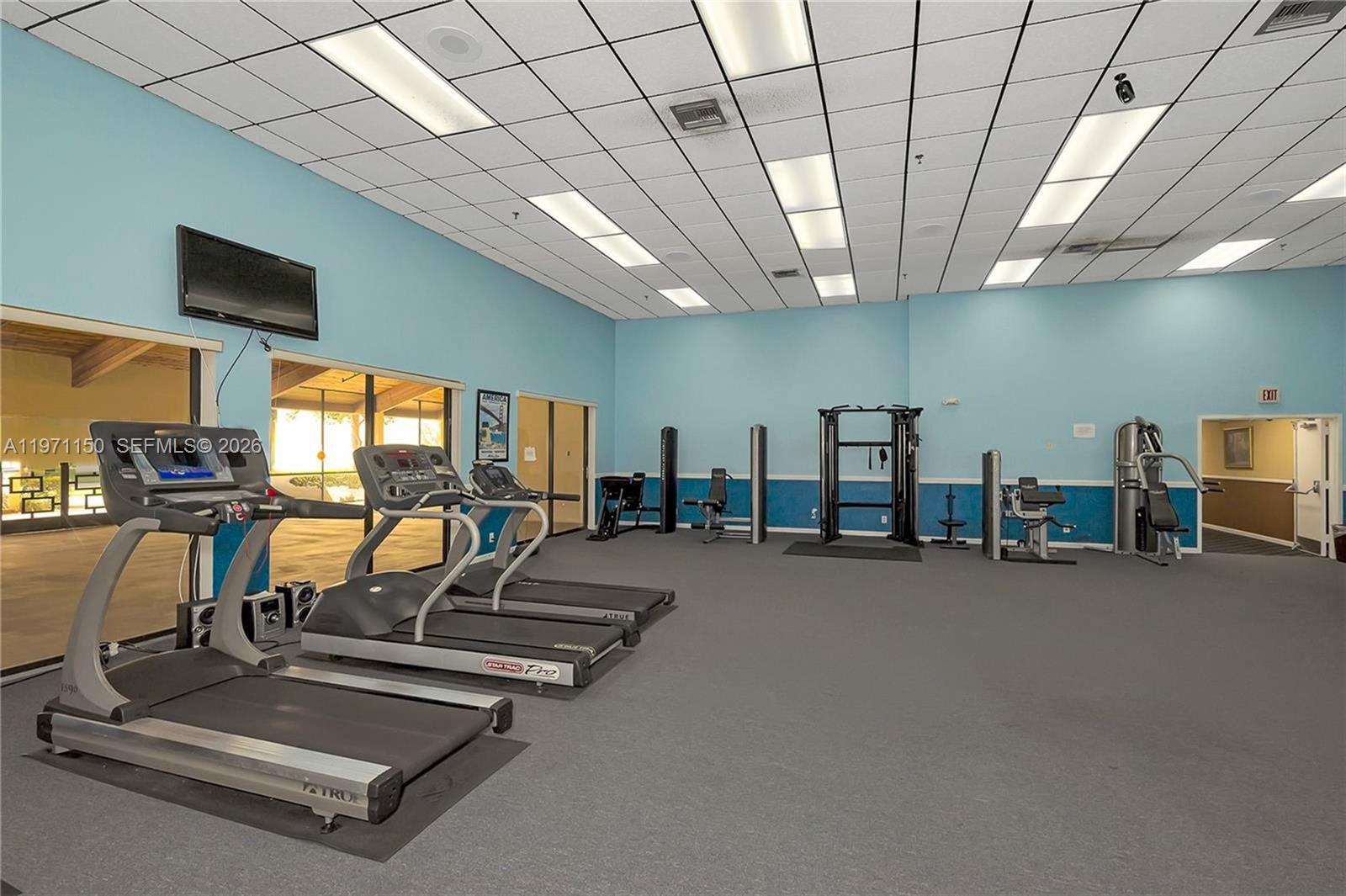 9430 Boca Cove Circle, Unit 210 Boca Raton, FL 33428 - Photo 22 of 24 a view of a room with gym equipment
