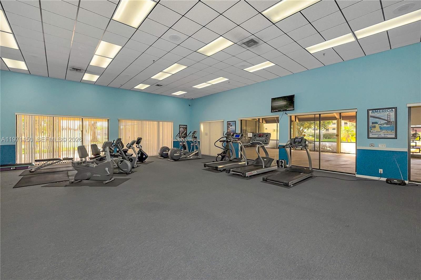 9430 Boca Cove Circle, Unit 210 Boca Raton, FL 33428 - Photo 23 of 24 a view of a room with gym equipment
