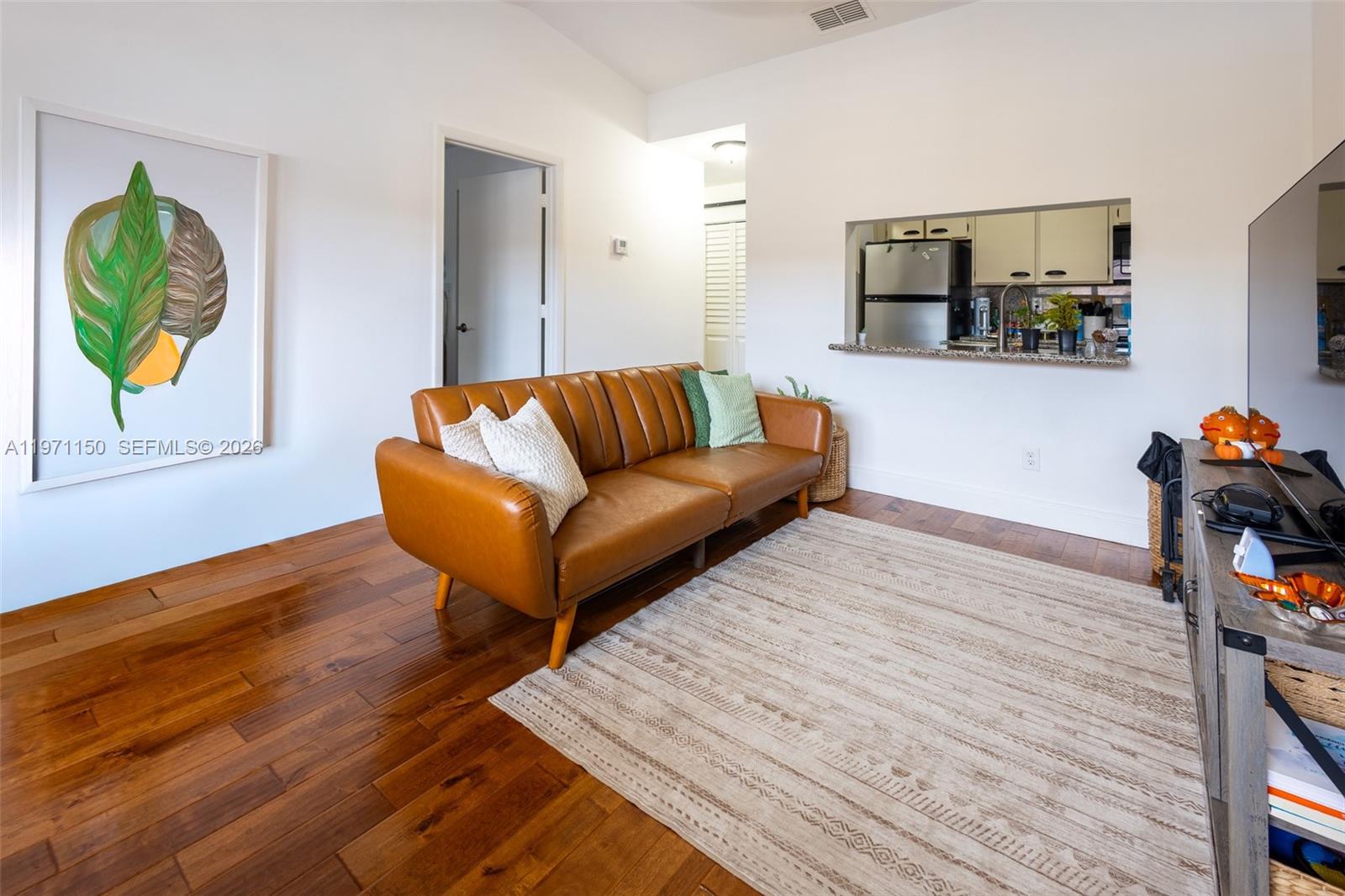 9430 Boca Cove Circle, Unit 210 Boca Raton, FL 33428 - Photo 3 of 24 a living room with hard wood floors and a wooden floor