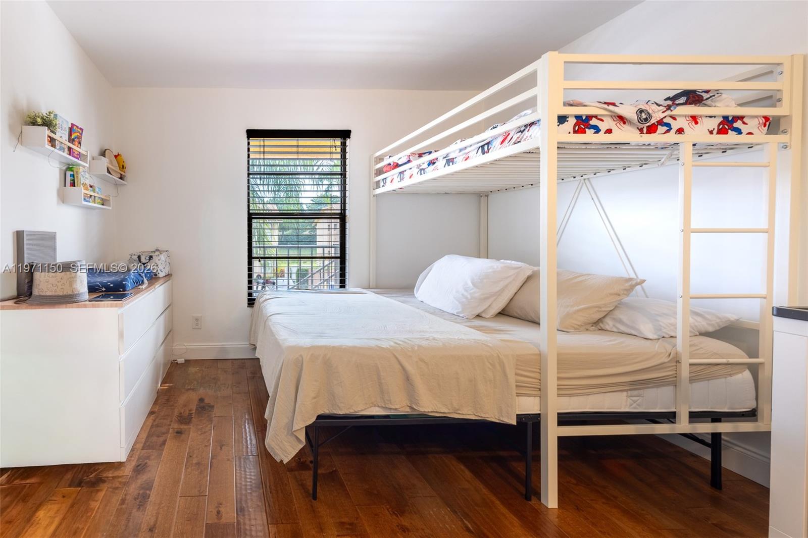 9430 Boca Cove Circle, Unit 210 Boca Raton, FL 33428 - Photo 5 of 24 a bedroom with a bed and a window