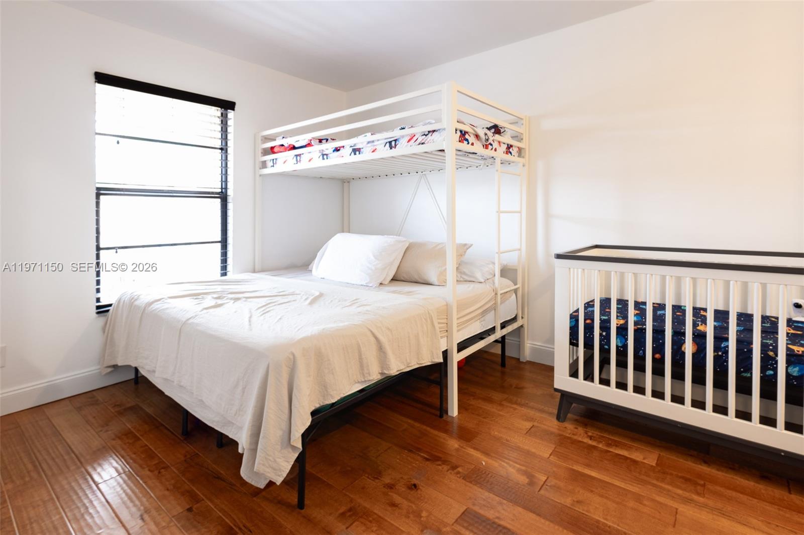 9430 Boca Cove Circle, Unit 210 Boca Raton, FL 33428 - Photo 6 of 24 a bedroom with a bed and a window