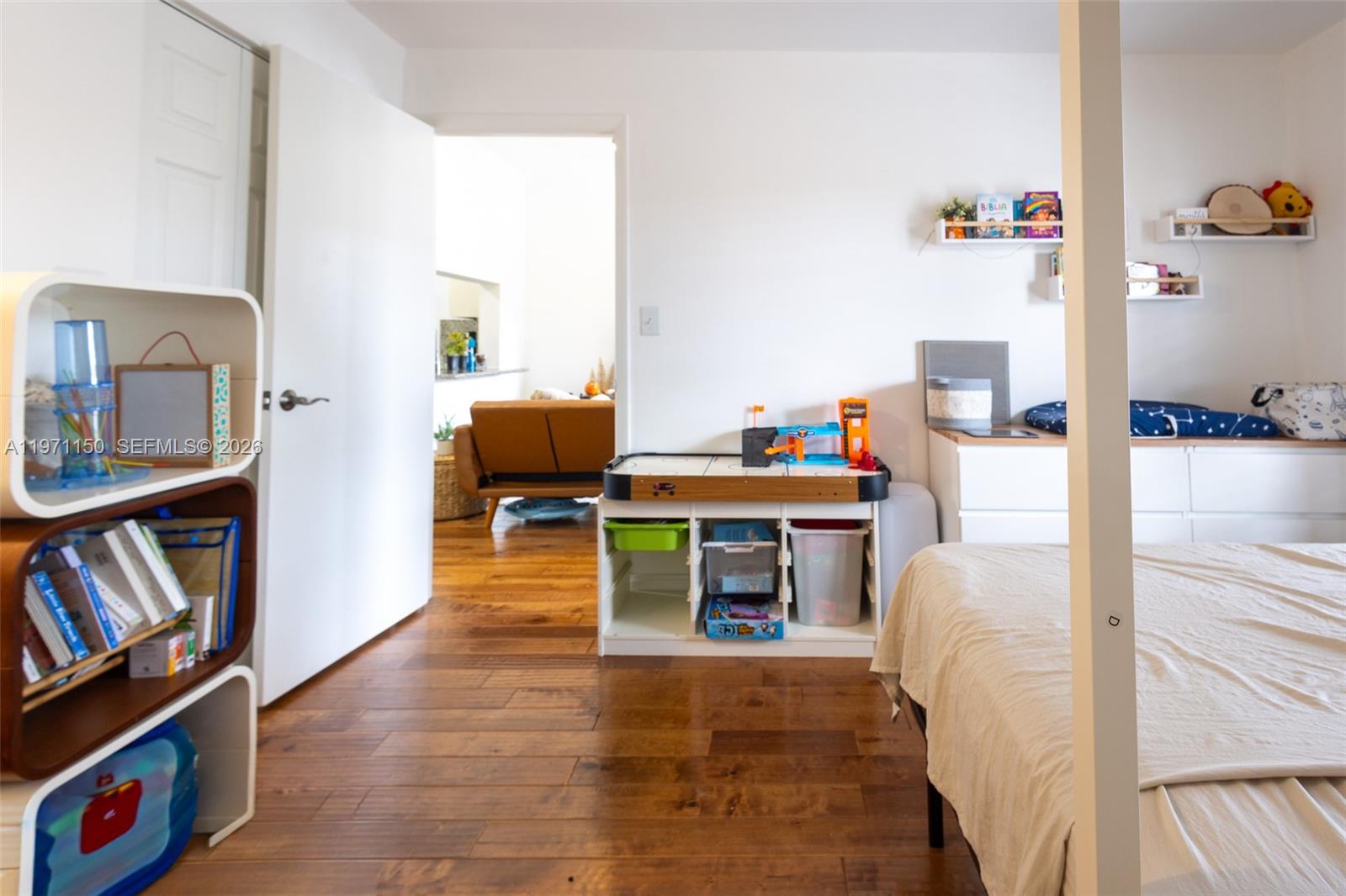 9430 Boca Cove Circle, Unit 210 Boca Raton, FL 33428 - Photo 7 of 24 a living room with furniture and a baby crib
