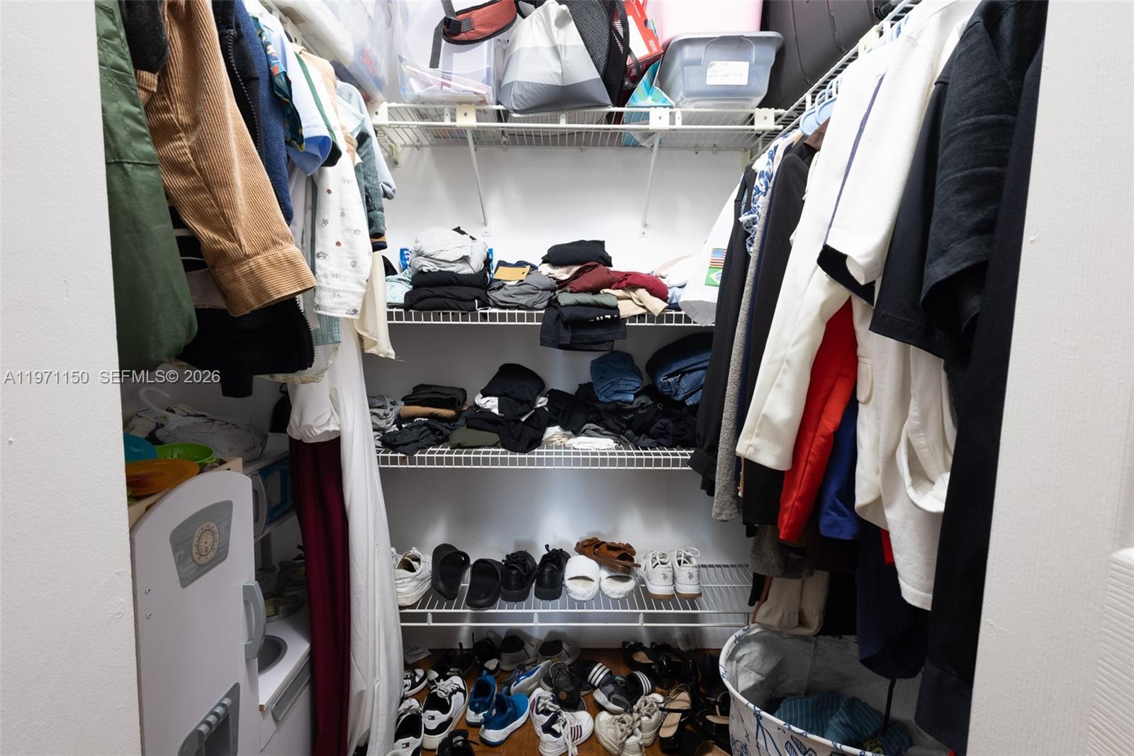 9430 Boca Cove Circle, Unit 210 Boca Raton, FL 33428 - Photo 8 of 24 a view of walk in closet with clothes and shoes