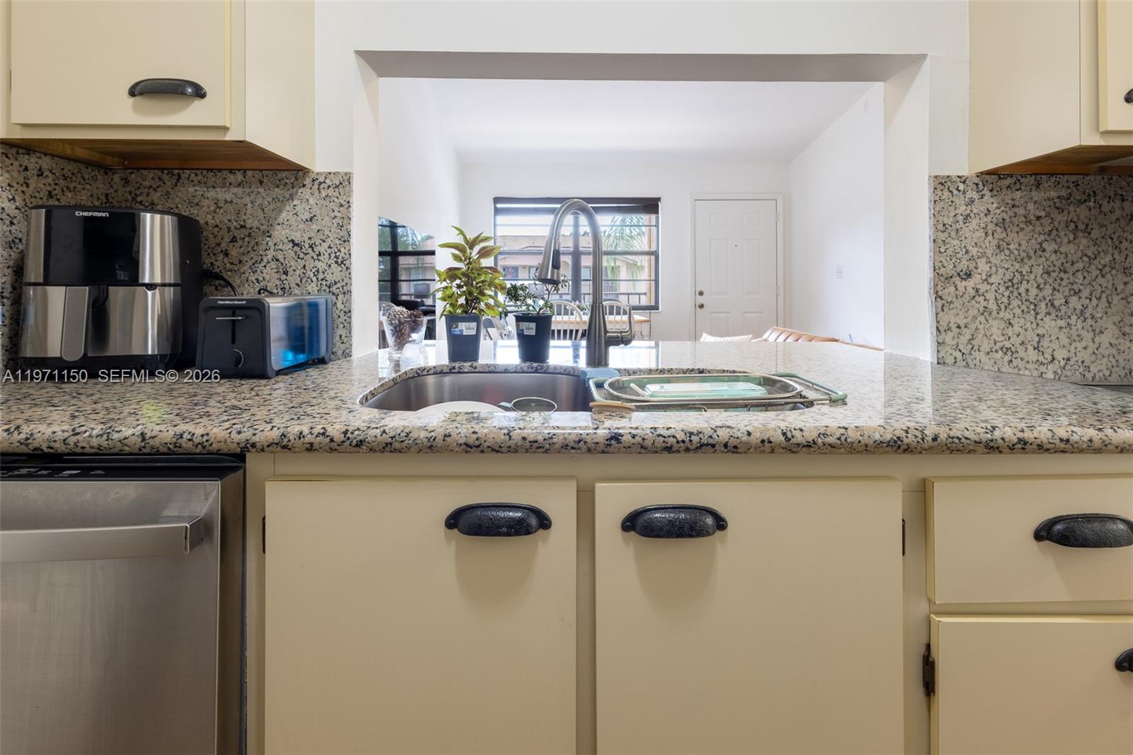 9430 Boca Cove Circle, Unit 210 Boca Raton, FL 33428 - Photo 10 of 24 a kitchen with granite countertop a sink and a granite counter tops