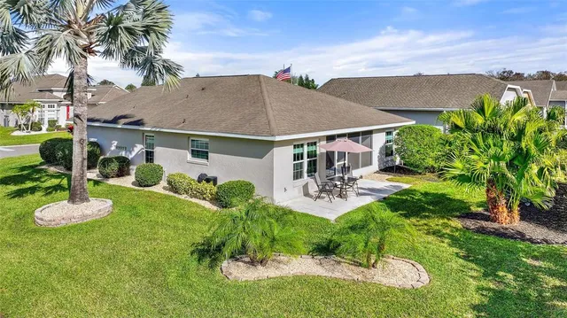 an aerial view of a house with a yard and potted plants