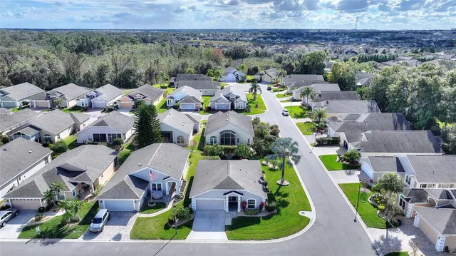 an aerial view of a house with a yard and lake view