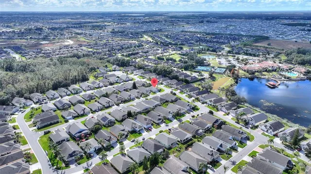 an aerial view of a house a yard swimming pool and outdoor seating