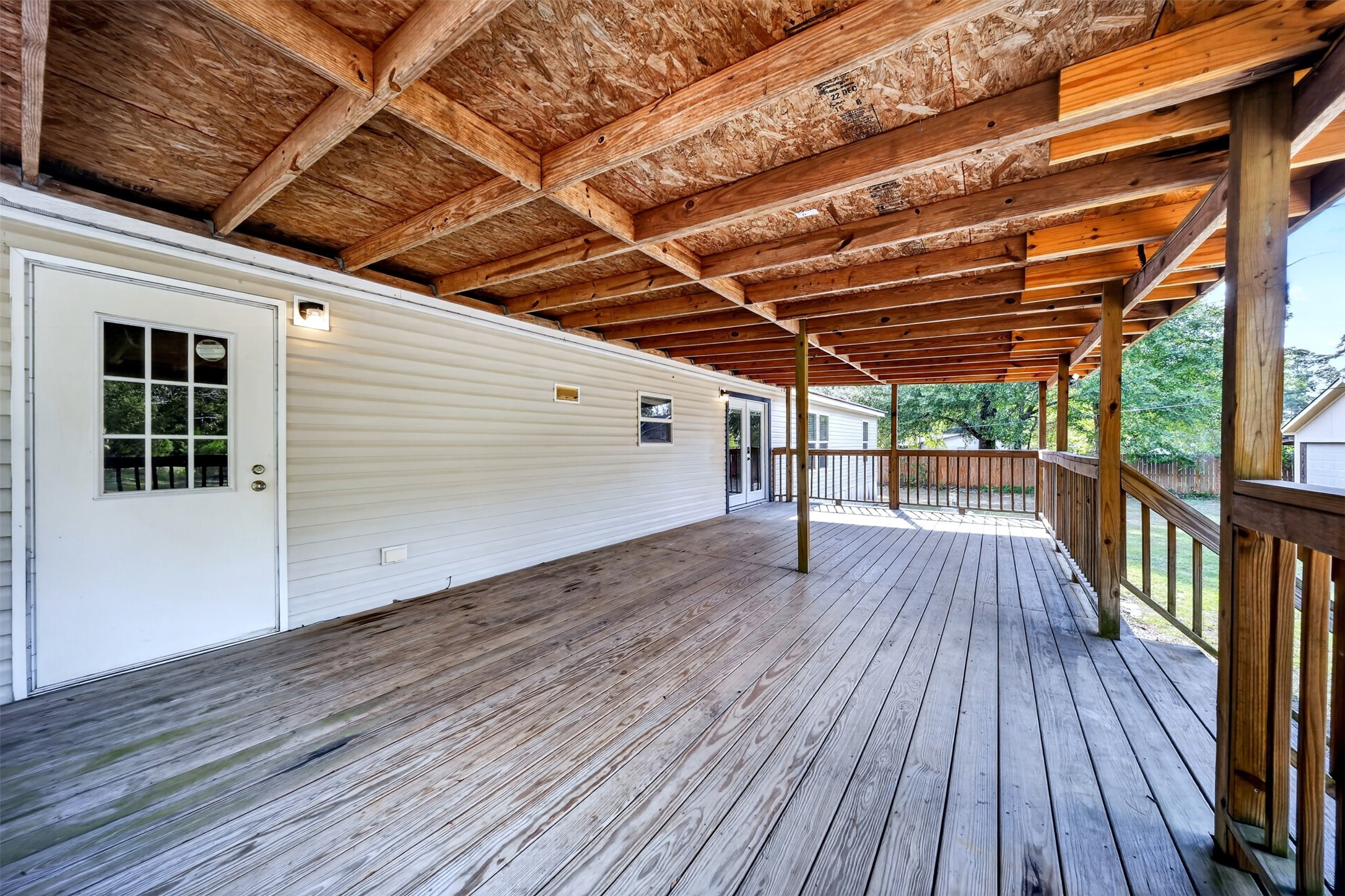 2581 Mann Road Conroe, TX 77303 - Photo 25 of 32 Expansive covered deck offering plenty of room for outdoor seating and entertaining.