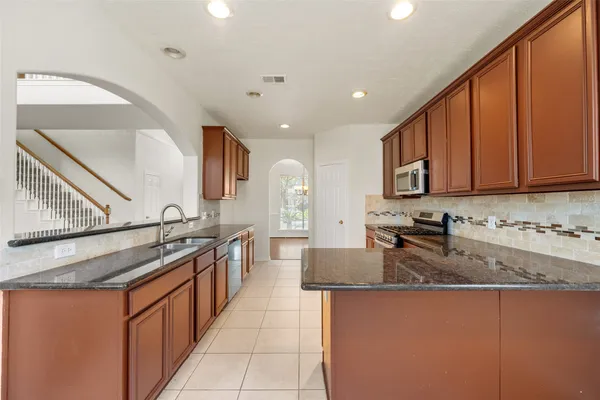 a view of staircase and kitchen with sink