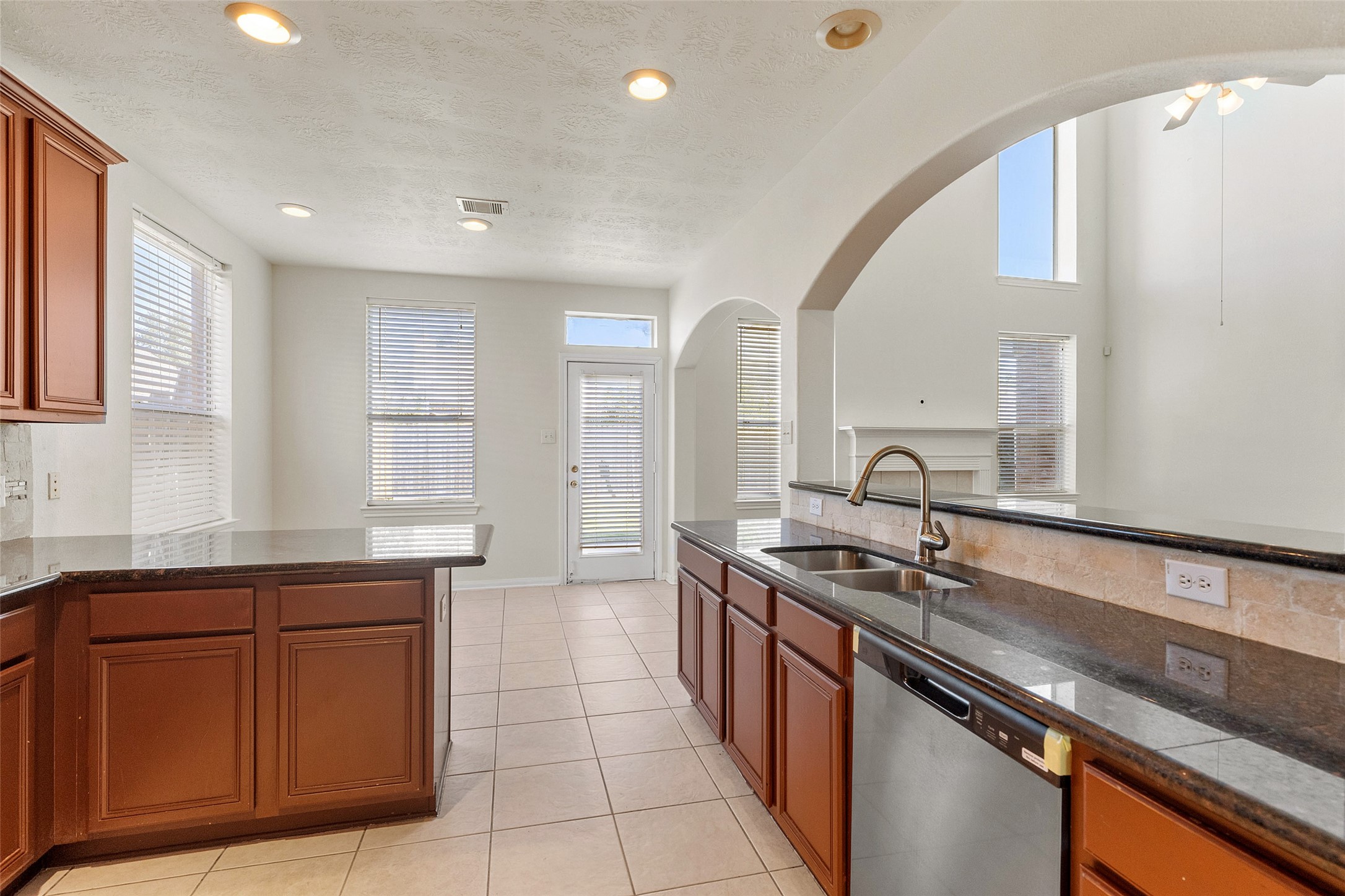 14213 Stone Bluff Lane Rosharon, TX 77583 - Photo 14 of 45 a kitchen with a sink and a stove top oven