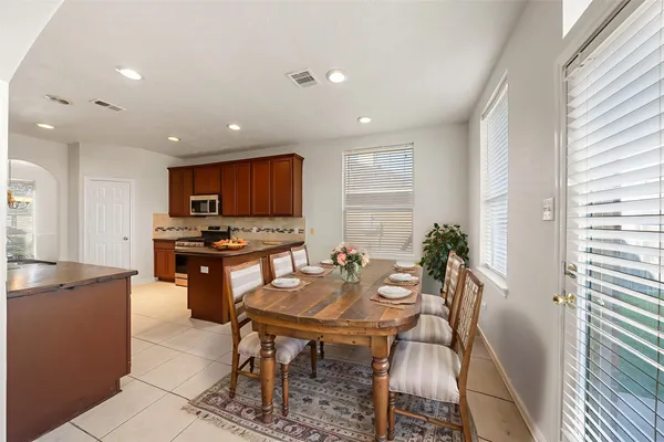 a kitchen with granite countertop a stove a sink and a microwave