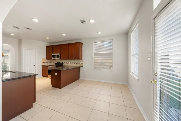 a kitchen with a table and chairs in it
